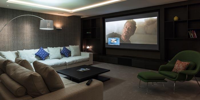 Lounge with large television displaying a movie